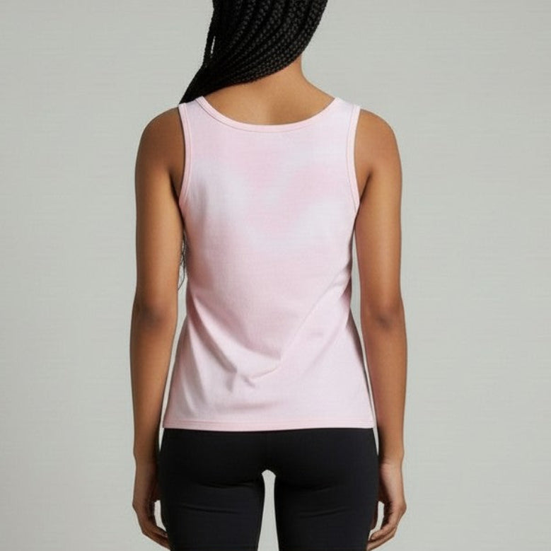 Person wearing a light pink sleeveless top and black shorts on a plain background